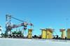 Credit - GDLM. Portsmouth Marine Terminal marshalling yard for the Coastal Virginia Offshore Wind development, with DEME’s Orion behind monopiles and transition pieces LO RES