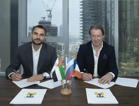 MYCRANE founder Andrei Geikalo, left, signs a partnership agreement with new UAE and Oman franchise partner Kirill Vishensky